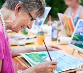 elderly creating art in a group outside