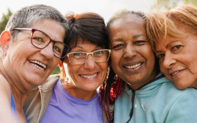 group of happy older adults laughing together outdoors